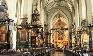 Wnętrze kościoła św. Mikołaja w Gdańsku, pełne bogatych zdobień i ołtarzy.