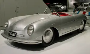 Srebrny kabriolet Porsche 356 z czerwonym wnętrzem, prezentowany na wystawie.