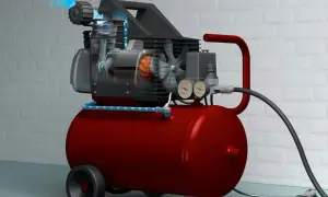 En röd kompressor med genomskuren motor som visar hur luften flödar, redo att måla med tryckluft.