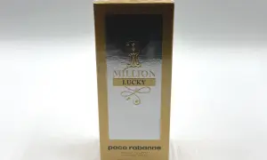Złote opakowanie Paco Rabanne 1 Million Lucky 100ml z napisem "MILLION LUCKY" i ozdobnymi elementami.