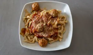 Sagne ncannulate con polpette al sugo, un piatto ricco e saporito, pronto per essere gustato.