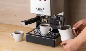Gaggia Classic w rankingu ekspresów do kawy do 2000 zł. Parzy kawę do filiżanki, obok dzbanek na mleko.