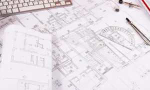 Rzut pokoju z widocznym planem architektonicznym, klawiaturą, cyrklem i linijką.