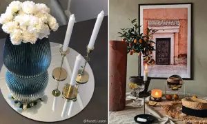 Vacker spegel vid matbordet reflekterar en vas med vita blommor och ljusstakar.