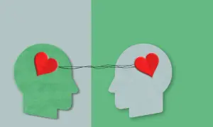 Twee profielen met harten verbonden door lijnen, symboliseren autisme en empathie.