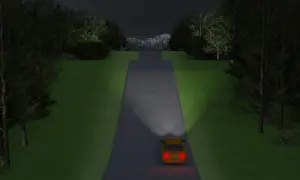 En gul bil kör på en mörk väg. Belysning av bilen är viktig för att följa trafikregler och se faran.