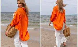 Kobieta w pomarańczowej koszuli i białych spodniach na plaży. Idealne outfity na lato, z plecioną torbą.