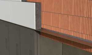 Warstwa izolacji styropianowej z białymi płytkami, pod nią ciemna membrana. Obok ceglana elewacja. Zastanawiasz się, co rozpuszcza styropian?