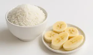Riso bianco in una ciotola e fette di banana su un piattino, ingredienti ideali per una dieta astringente.