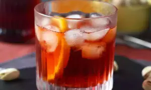 En klassisk negroni med is och apelsinskiva. Perfekt för att njuta av ett negroni recept.