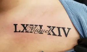 Tatuaż na torsie z rzymskimi cyframi LXIII i XIV, a pośrodku imię "Miguel".