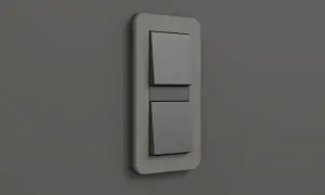 Ein moderner Gira E3 Lichtschalter mit zwei grauen Wippen auf einer hellgrauen Wand.