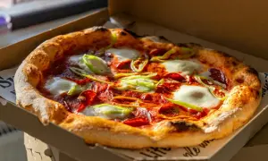 Pyszna pizza z pepperoni, mozzarellą i papryką w pudełku. Idealna na wieczór, gdy zastanawiasz się, skąd pochodzi pizza.