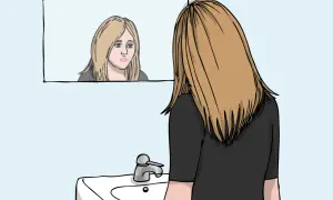 En ung kvinna med blont hår ser sig i spegeln, hennes ansiktsuttryck tyder på oro. Kanske kämpar hon med tankar relaterade till ocd svenska.
