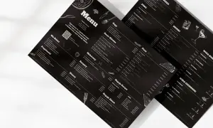 Menu z czarnym tłem, prezentujące ofertę a la carte. Widoczne sekcje: Zupy, Dania Główne, Makaron, Burgery, Desery, Napoje Gorące, Napoje Zimne, Pizza, Piwo, Drink, Wina.