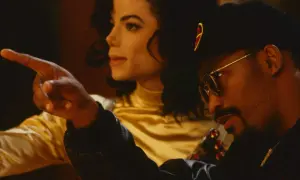 Teddy Riley points as Michael Jackson looks on, a moment captured during their creative collaboration.