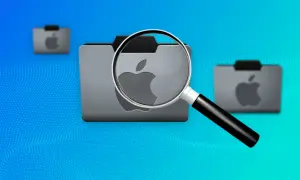 Lupa powiększa ikonę folderu z logo Apple, symbolizując funkcję finder w systemie macOS.