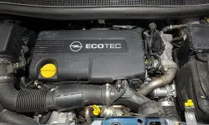 Silnik Ecotec w Opel Meriva 1.7 CDTI. Widoczny czarny plastikowy dekiel z logo Opla i napisem Ecotec, żółty korek oleju, przewody i elementy układu dolotowego.