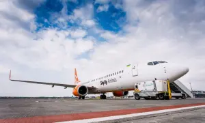 Samolot SkyUp Airlines gotowy do startu. W tle błękitne niebo z chmurami.