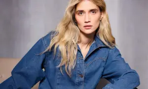 Kobieta z blond włosami w dżinsowej kurtce, w ujęciu monochromatycznym.