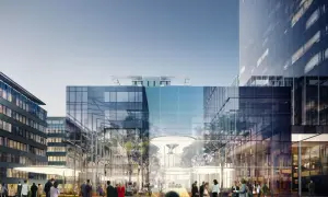 Nowoczesny kompleks biurowy z najwyższym budynkiem w Trójmieście. Ludzie spacerują po placu przed przeszklonymi fasadami.