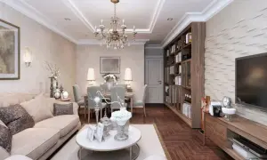 Elegancki salon z jadalnią, gdzie króluje styl w domu. Jasna sofa, kryształowy żyrandol i regał z książkami tworzą przytulną atmosferę.