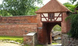 Brama miejska w Pasłęku, z charakterystycznym szachulcowym piętrem i ceramicznym dachem, to jedna z głównych atrakcji miasta.