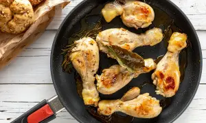 Cosce di pollo in padella, dorate e succulente, con rosmarino e alloro. Accompagnate da panini integrali.