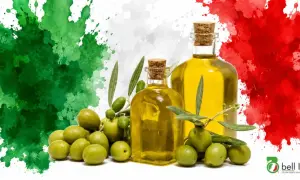 Bottiglie di olio extravergine d'oliva e olive fresche, con sfondo a macchie verdi, bianche e rosse, che ricordano la bandiera italiana. La migliore classifica olio extravergine di oliva.