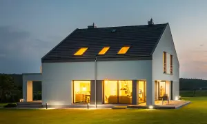 Nowoczesny dom z jasnym, gładkim tynkiem zewnętrznym, który podkreśla jego architekturę. Różne rodzaje tynków zewnętrznych mogą nadać budynkowi unikalny charakter.