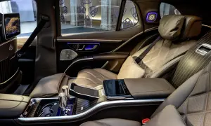 Luksusowe wnętrze Maybach SUV z brązową, pikowaną skórą, ekranami i ambientowym oświetleniem.