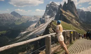 Dziewczyna podziwia spektakularne **dolomity co zobaczyć** – skaliste szczyty i zielone doliny.