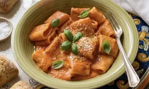 Herzhafte Paccheri in cremiger Tomatensoße, garniert mit Basilikum und Parmesan. Ein Genuss für alle Paccheri Rezepte Liebhaber.