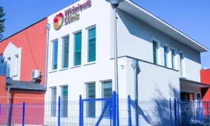 Nowoczesny budynek kliniki Wiśniowa Clinic w Zielonej Górze z niebieskim ogrodzeniem.