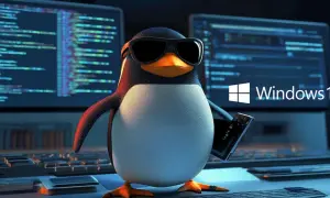 Pingwin w okularach trzyma tablet, a za nim ekrany z kodem i logo Windows 10. To jakby "windows to go" dla pingwinów!
