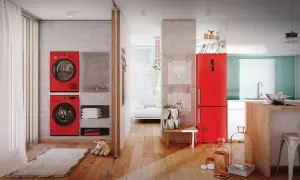 Dwie czerwone pralki i suszarka łazienkowa elektryczna w nowoczesnym wnętrzu.
