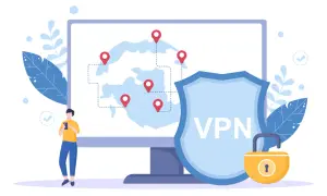 Osoba korzysta z telefonu, a na ekranie komputera widać mapę z lokalizacjami i tarczę z napisem VPN.