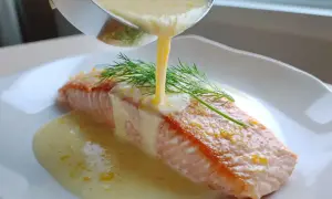 En saftig laxfilé serveras med en krämig citronsås och dill.