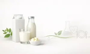 Mleko UHT w kartonie i butelce, szklanka mleka, masło. Grafika symbolizuje zdrowie i badania, sugerując pytanie: czy mleko UHT jest zdrowe?
