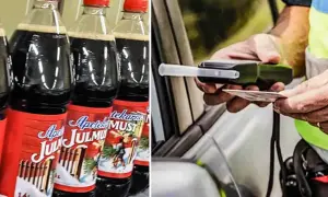 Bottles of Julmust and a person holding a breathalyzer and ID.