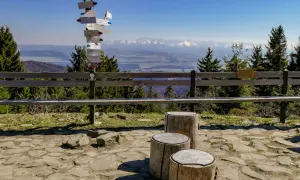 Widok z Turbacza na Tatry. Znak szlaków turystycznych wskazuje drogę do Nowego Targu.