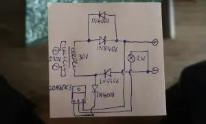 Rysunek schematu prostownika 12V z transformatorem, diodami i żarówką.
