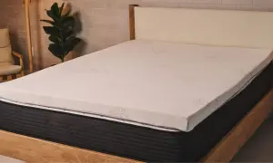 A new mattress with a white topper. This image helps answer: should I put a mattress topper on a new mattress?