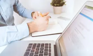 Mężczyzna notuje, planując finanse na 2025 rok, uwzględniając drugi próg podatkowy.