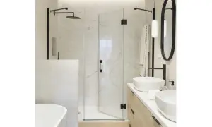 Modern bathroom with a glass shower enclosure, a built-in shower wall, and a freestanding bathtub.