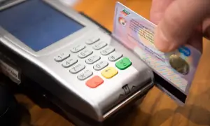 Zbliżenie na terminal płatniczy, gdzie ręka wsuwa kartę. Szybki zwrot na kartę z terminala ile trwa?