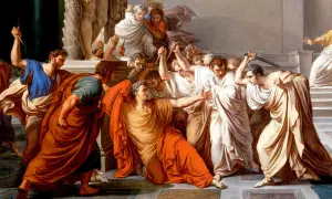 Män i toga omringar och attackerar Julius Caesar med knivar.