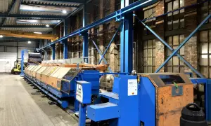 Linia produkcyjna w hali przemysłowej, z widocznym sterowaniem i elementami automatyki. To idealne miejsce na poradnik automatyka.