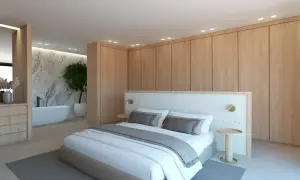 Dormitorio moderno con cama king size, armarios de madera y un baño suite con bañera exenta y pared de mármol.