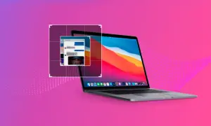 Laptop z otwartym oknem czatu na tle gradientu fioletowo-różowego.